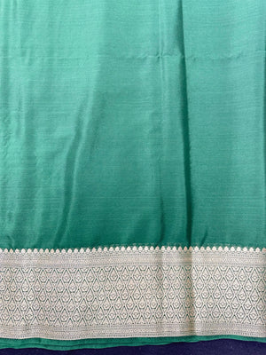 Woman wearing a Binny Crepe Saree with soft, flowing drape and minimal sheen, ideal for office and everyday wear.