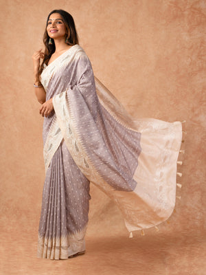 Woman wearing a Milky Cutwork Tussar Silk Saree with delicate embroidery and soft drape, ideal for weddings, receptions, and festive occasions.