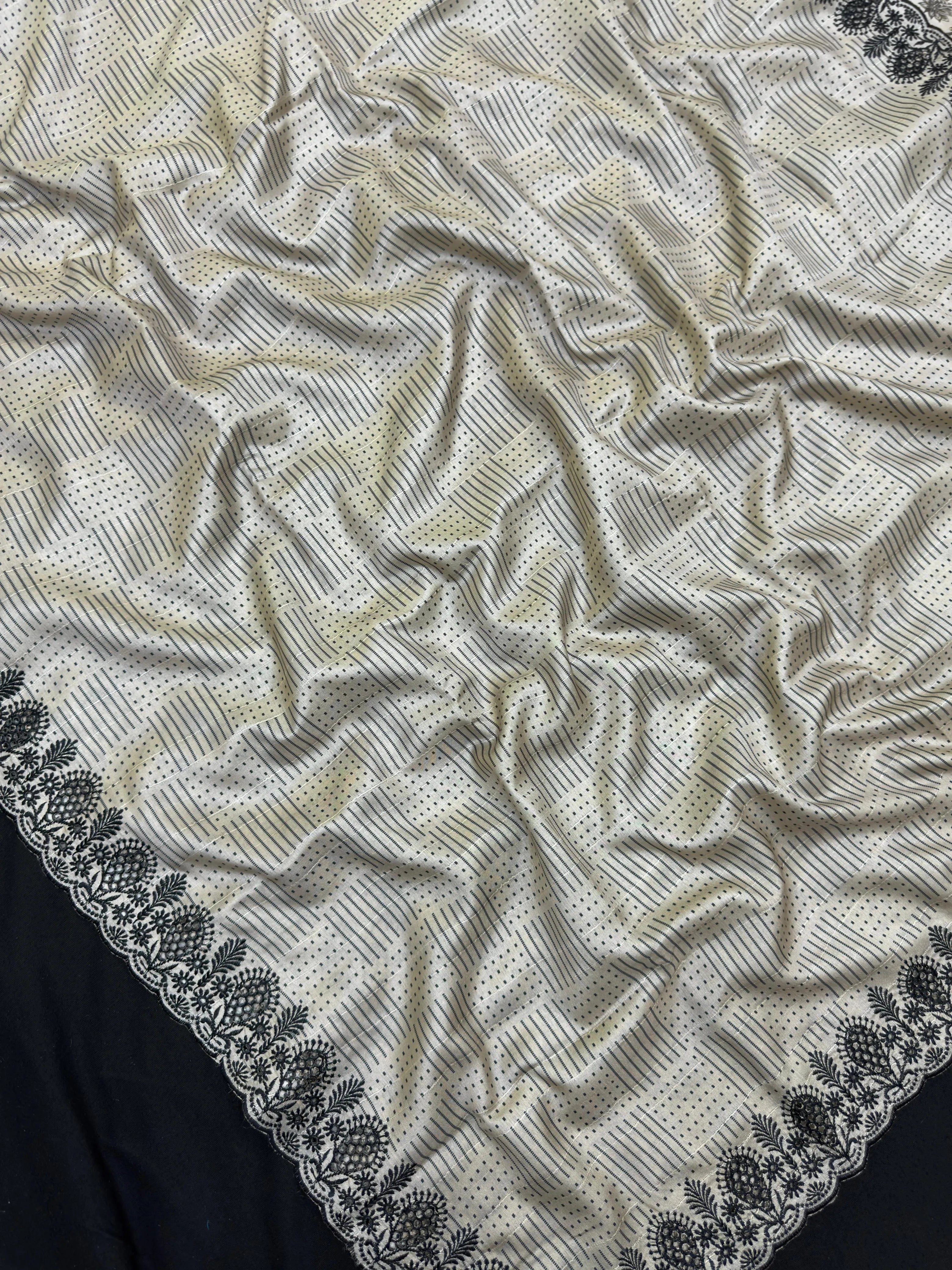 Woman wearing a Milky Cutwork Tussar Silk Saree with delicate embroidery, ideal for day functions and festive occasions.