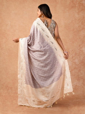 Woman wearing a Milky Cutwork Tussar Silk Saree with delicate embroidery and soft drape, ideal for weddings, receptions, and festive occasions.