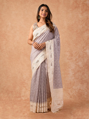 Woman wearing a Milky Cutwork Tussar Silk Saree with delicate embroidery and soft drape, ideal for weddings, receptions, and festive occasions.
