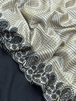 Woman wearing a Milky Cutwork Tussar Silk Saree with delicate embroidery, ideal for day functions and festive occasions.