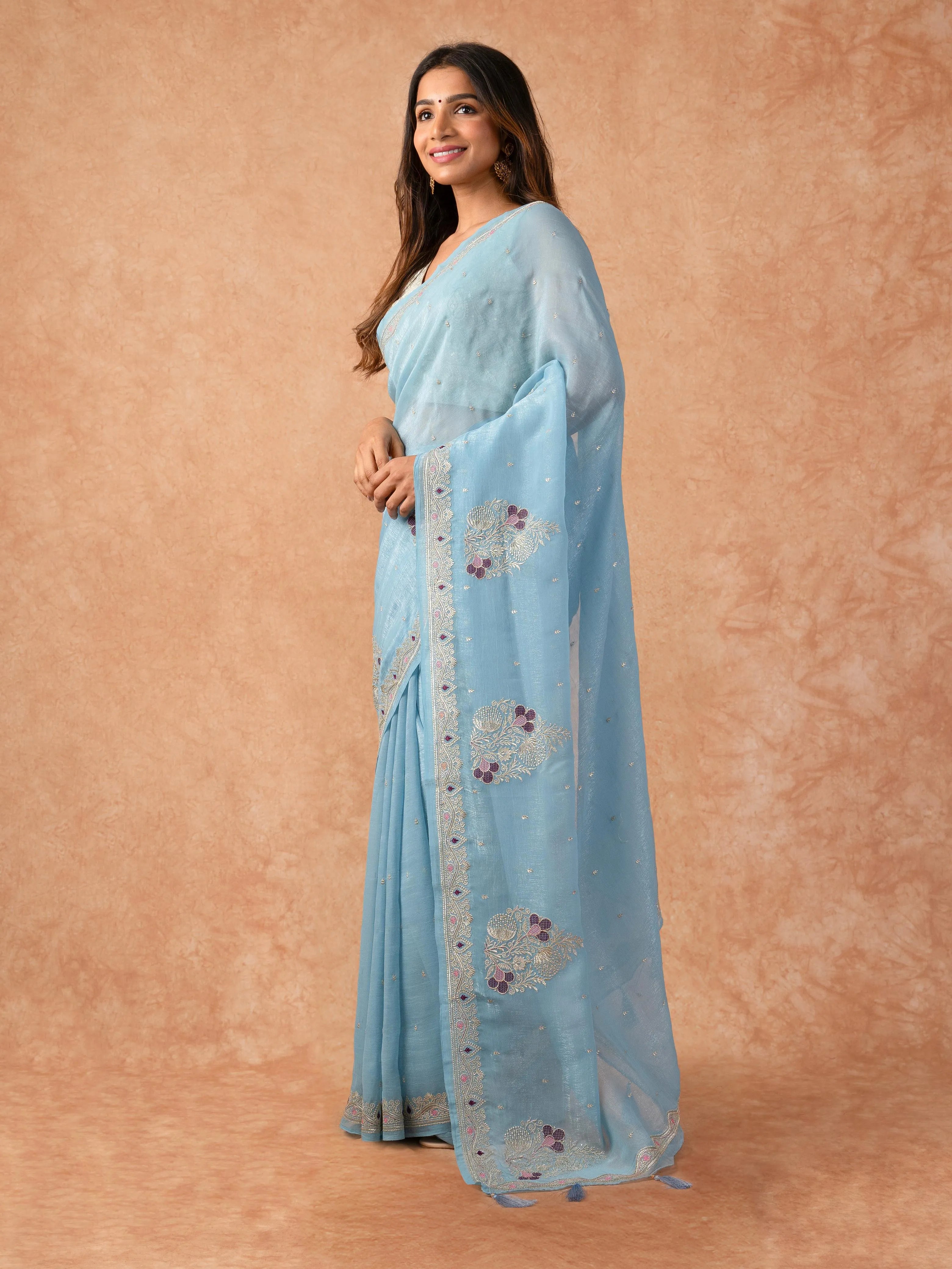 Woman wearing a Paper Silk Saree with lightweight, crisp texture and subtle sheen, ideal for office, casual, and festive occasions.