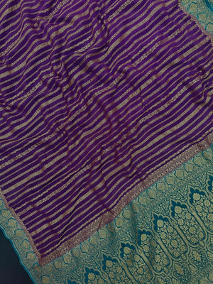 Woman wearing a Pure Banarasi Crepe Silk Saree with intricate zari motifs and flowing texture, perfect for weddings and special occasions.