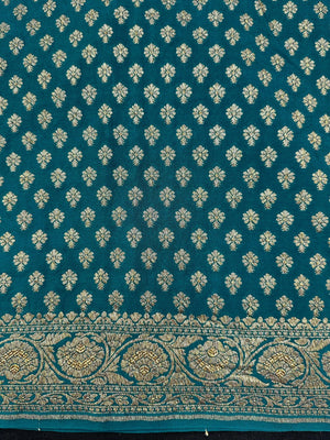 Woman wearing a Pure Banarasi Crepe Silk Saree with intricate zari motifs and flowing texture, perfect for weddings and special occasions.