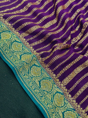 Woman wearing a Pure Banarasi Crepe Silk Saree with intricate zari motifs and flowing texture, perfect for weddings and special occasions.