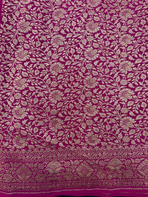 Woman draped in a Pure Banarasi Crepe Silk Saree with soft crepe texture and intricate zari work, perfect for weddings and festive occasions.