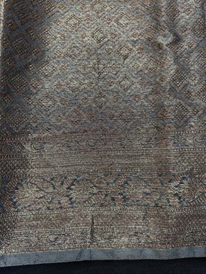 Woman wearing a traditional Chinya Silk Saree in elegant colors with woven pallu and festive motifs, ideal for weddings and Indian celebrations.