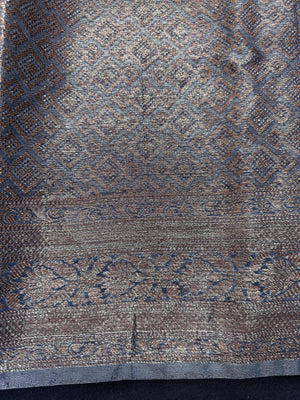 Woman wearing a traditional Chinya Silk Saree in elegant colors with woven pallu and festive motifs, ideal for weddings and Indian celebrations.