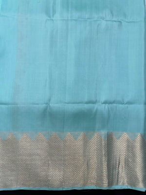 Woman draped in a Pure Kanjivaram Silk Saree with rich silk texture, vibrant colors, and traditional zari border, ideal for weddings and festivals.