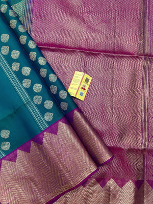 Woman draped in a Pure Kanjivaram Silk Saree with rich silk texture, vibrant colors, and traditional zari border, ideal for weddings and festivals.
