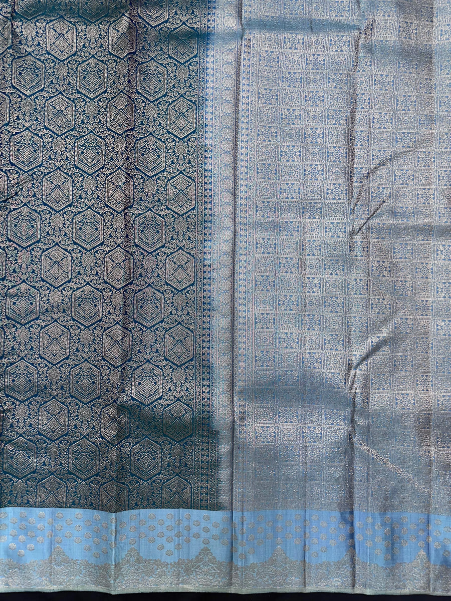 Woman draped in a Pure Kanjivaram Silk Saree with rich zari border, vibrant colors, and traditional motifs, ideal for weddings and festive occasions.