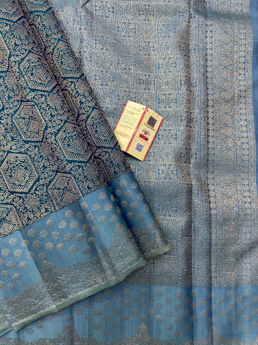 Woman draped in a Pure Kanjivaram Silk Saree with rich zari border, vibrant colors, and traditional motifs, ideal for weddings and festive occasions.