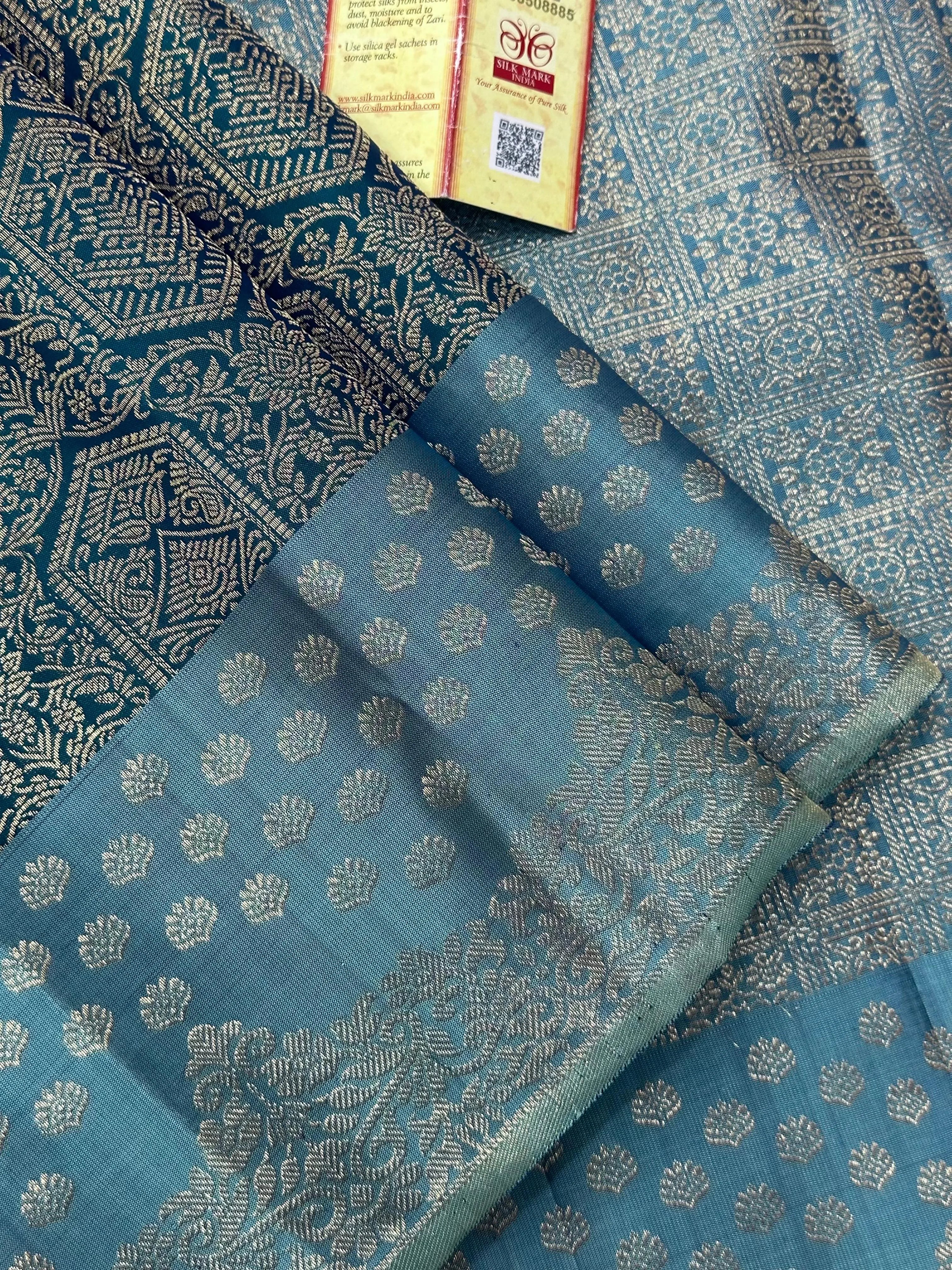 Woman draped in a Pure Kanjivaram Silk Saree with rich zari border, vibrant colors, and traditional motifs, ideal for weddings and festive occasions.