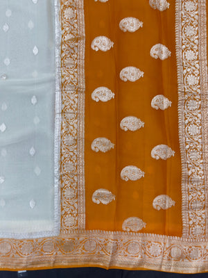 Woman wearing a Pure Khaddi Chiffon Saree with zari border and flowing drape – ideal for weddings and festive occasions.