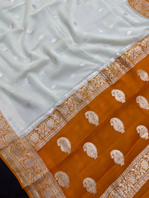 Woman wearing a Pure Khaddi Chiffon Saree with zari border and flowing drape – ideal for weddings and festive occasions.