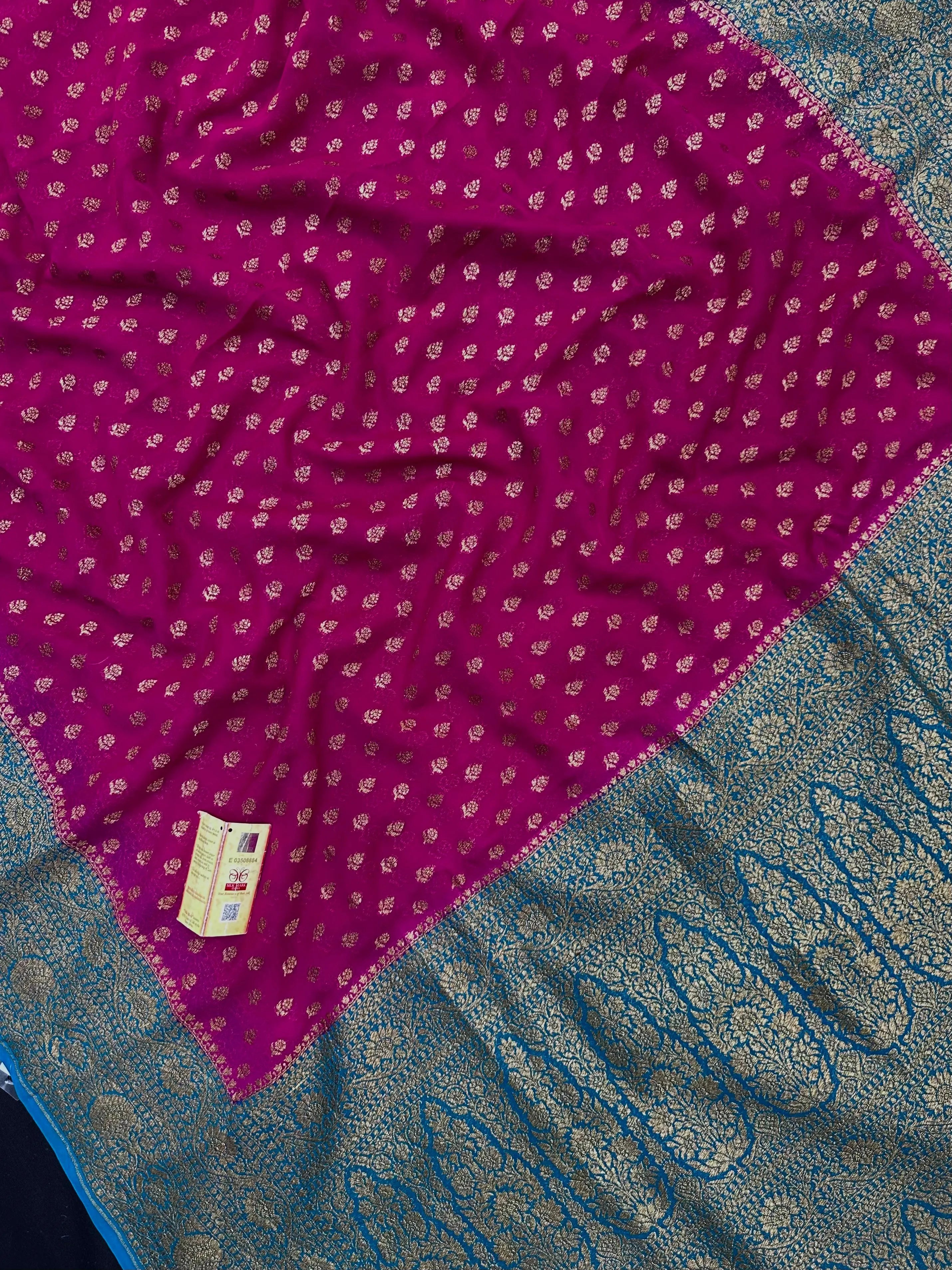 Woman wearing a Pure Khaddi Georgette Saree with rich zari work and flowing drape β ideal for festive and traditional occasions.