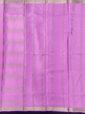 Woman wearing a Pure Mysore Silk Saree with smooth drape and zari border, perfect for weddings and traditional South Indian events.