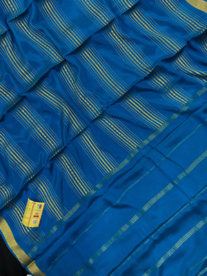 Woman wearing a Pure Mysore Silk Saree with smooth drape and zari border, perfect for weddings and traditional South Indian events.