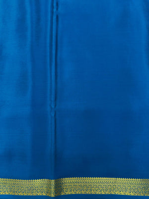 Woman wearing a Pure Mysore Silk Saree with smooth drape and zari border, perfect for weddings and traditional South Indian events.