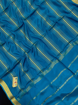 Woman wearing a Pure Mysore Silk Saree with smooth drape and zari border, perfect for weddings and traditional South Indian events.