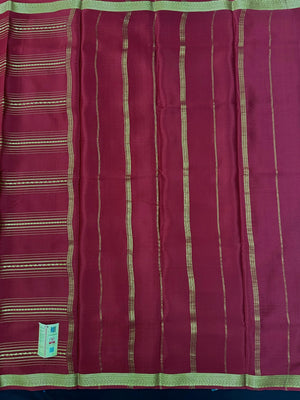 Woman wearing a Pure Mysore Silk Saree with smooth drape and zari border, perfect for weddings and traditional South Indian events.