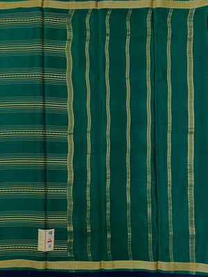 Woman wearing a Pure Mysore Silk Saree with smooth drape and zari border, perfect for weddings and traditional South Indian events.