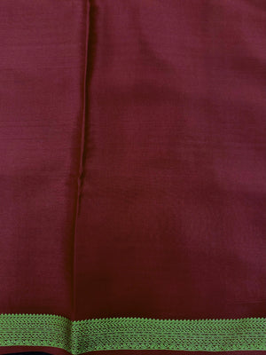 Woman wearing a Pure Mysore Silk Saree with smooth drape and zari border, perfect for weddings and traditional South Indian events.