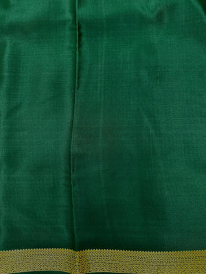 Woman wearing a Pure Mysore Silk Saree with smooth drape and zari border, perfect for weddings and traditional South Indian events.