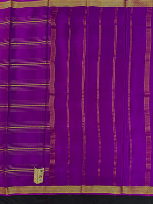 Woman wearing a Pure Mysore Silk Saree with smooth drape and zari border, perfect for weddings and traditional South Indian events.