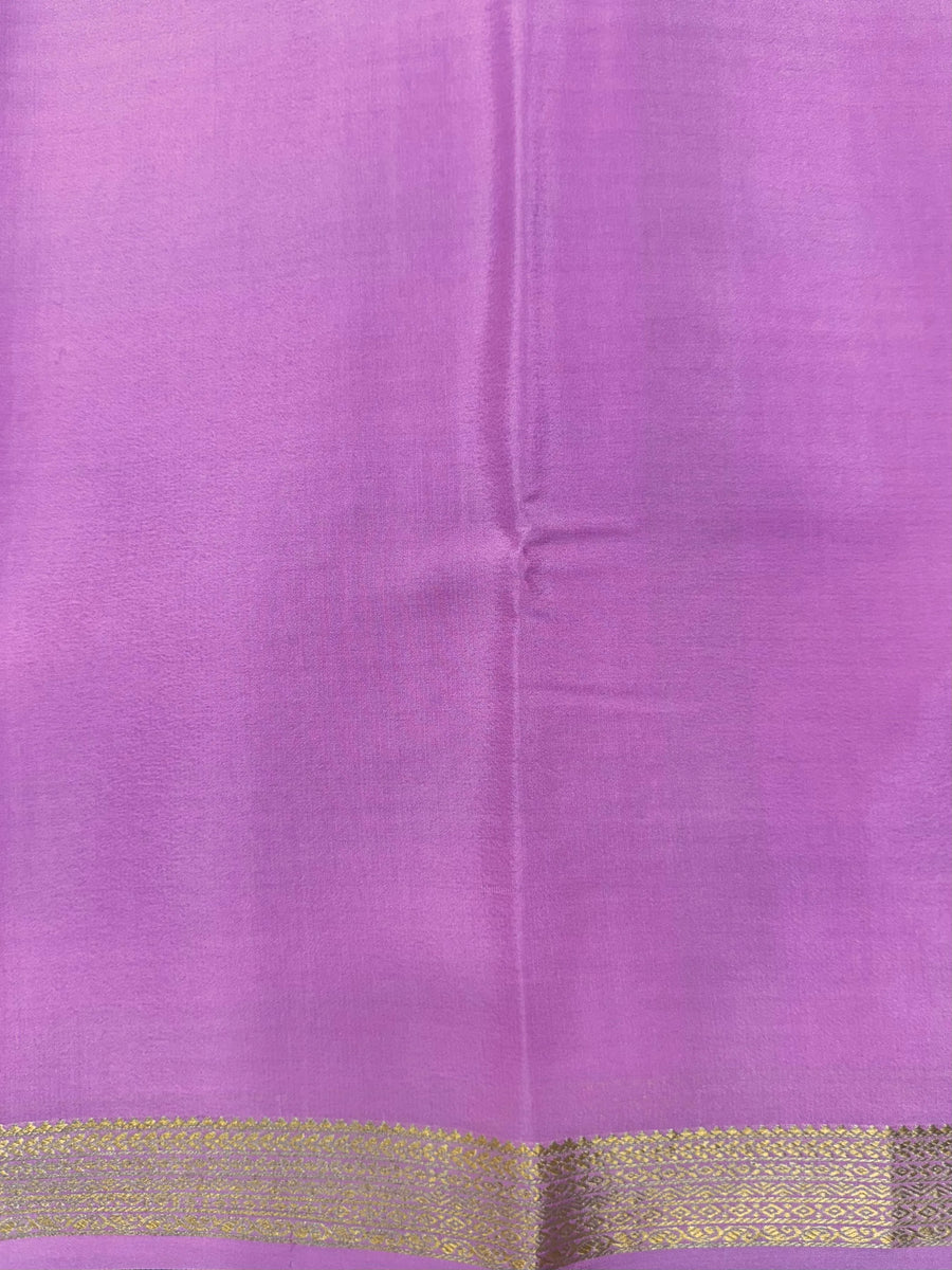 Woman wearing a Pure Mysore Silk Saree with smooth drape and zari border, perfect for weddings and traditional South Indian events.