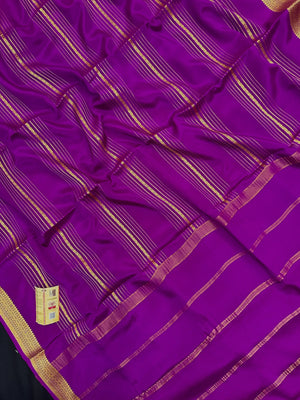 Woman wearing a Pure Mysore Silk Saree with smooth drape and zari border, perfect for weddings and traditional South Indian events.