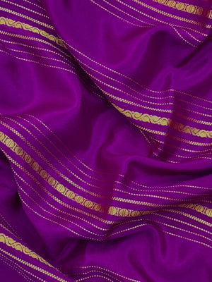 Woman wearing a Pure Mysore Silk Saree with smooth drape and zari border, perfect for weddings and traditional South Indian events.