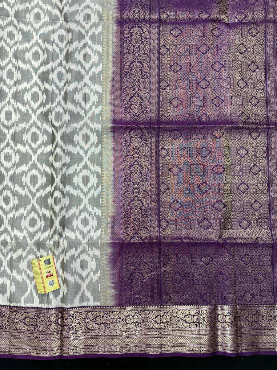 Woman draped in a Pure Pochampally Saree showcasing handwoven Ikat patterns in vibrant colors, representing traditional Telangana craftsmanship.