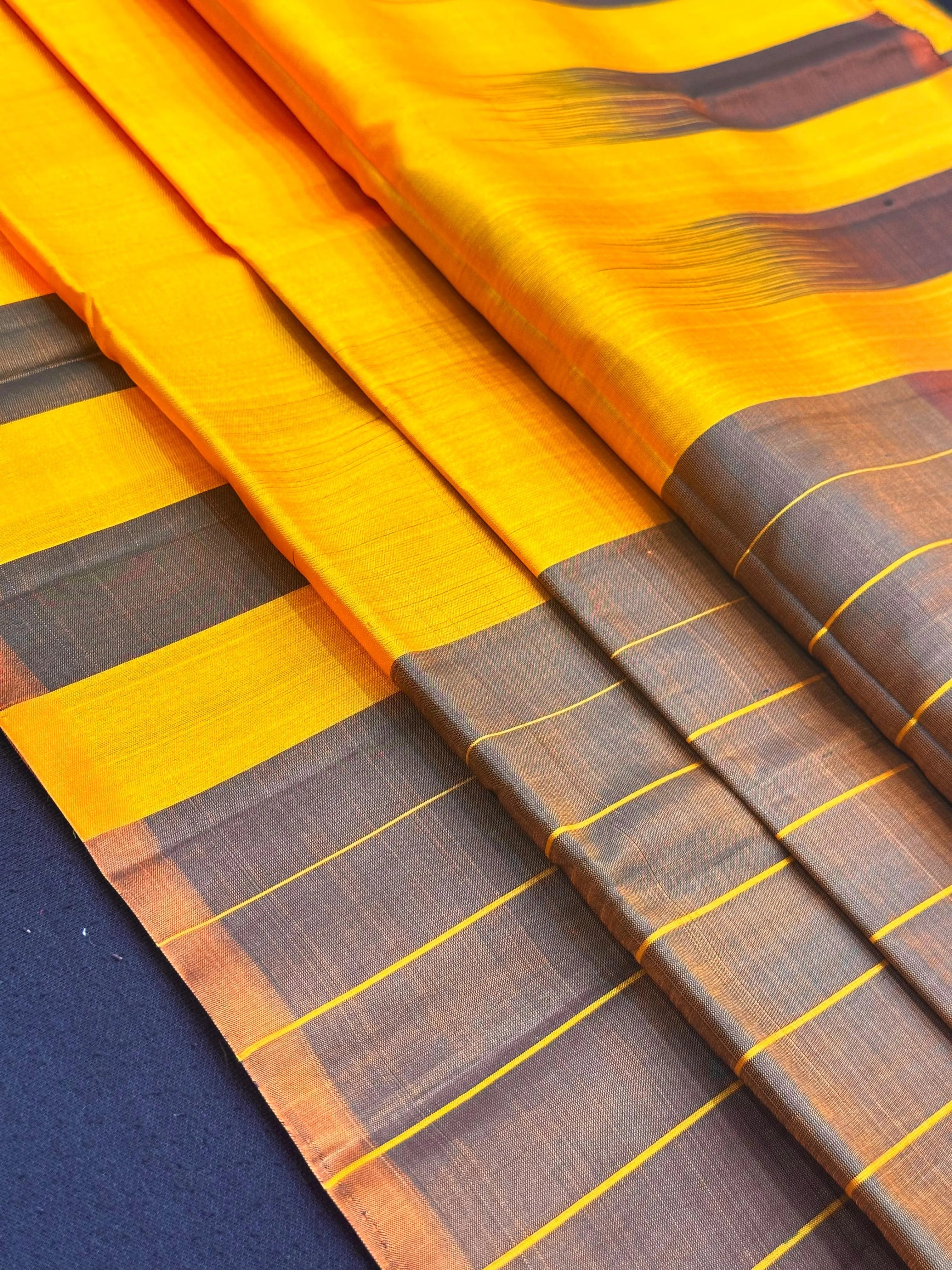 Woman draped in a Pure Silk Saree with lustrous finish and classic detailing – perfect for weddings and traditional celebrations.