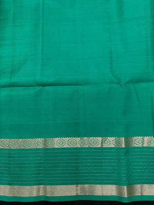 Woman wearing a Pure Silk Saree with glossy finish and intricate detailing, ideal for weddings and ethnic celebrations.