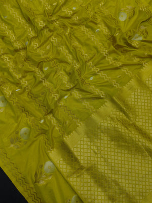 Woman wearing a Raw Mango Silk Saree with rich handloom texture and subtle sheen – perfect for weddings and festive occasions.