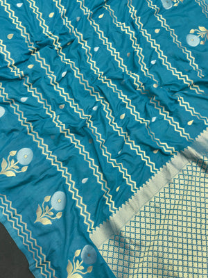 Woman wearing a Raw Mango Silk Saree with rich handloom texture and subtle sheen – perfect for weddings and festive occasions.