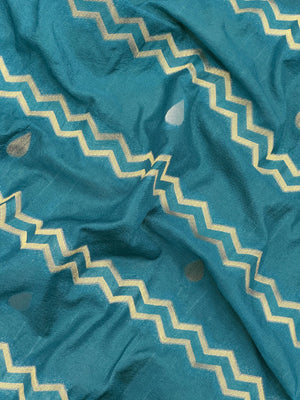 Woman wearing a Raw Mango Silk Saree with rich handloom texture and subtle sheen – perfect for weddings and festive occasions.