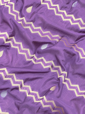 Woman wearing a Raw Mango Silk Saree with rich handloom texture and subtle sheen – perfect for weddings and festive occasions.