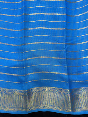 Woman draped in a Scarlet Chiffon Silk Saree with soft, flowing texture and elegant red hue, ideal for parties and festive occasions.