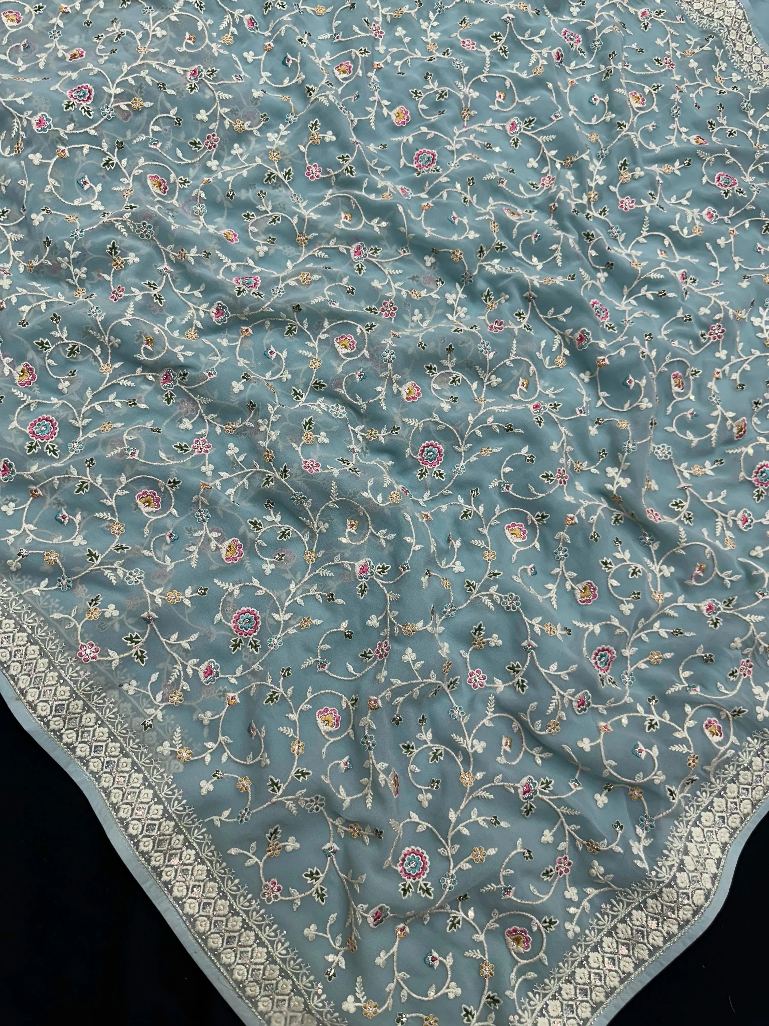 Woman wearing a Semi Georgette Silk Saree with a soft flowing drape and subtle shine, ideal for festive and formal occasions.