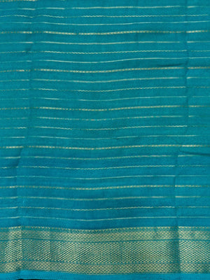 Woman wearing a Semi Silk Saree with elegant shine and festive border – perfect for ethnic functions and special occasions.
