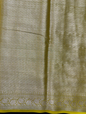 “Woman draped in a Semi Khaddi Georgette saree featuring intricate Banarasi motifs and a soft, flowy texture—perfect blend of tradition and lightness.”