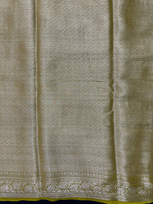 “Woman draped in a Semi Khaddi Georgette saree featuring intricate Banarasi motifs and a soft, flowy texture—perfect blend of tradition and lightness.”