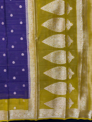 “Woman draped in a Semi Khaddi Georgette saree featuring intricate Banarasi motifs and a soft, flowy texture—perfect blend of tradition and lightness.”