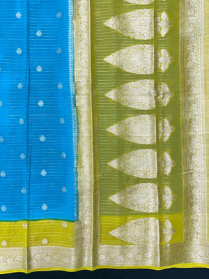 “Woman draped in a Semi Khaddi Georgette saree featuring intricate Banarasi motifs and a soft, flowy texture—perfect blend of tradition and lightness.”