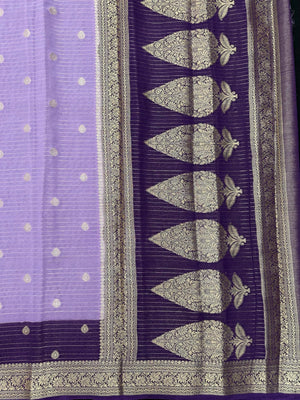 “Woman draped in a Semi Khaddi Georgette saree featuring intricate Banarasi motifs and a soft, flowy texture—perfect blend of tradition and lightness.”