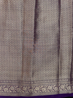 “Woman draped in a Semi Khaddi Georgette saree featuring intricate Banarasi motifs and a soft, flowy texture—perfect blend of tradition and lightness.”