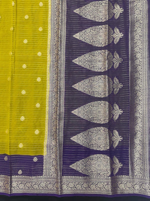 “Woman draped in a Semi Khaddi Georgette saree featuring intricate Banarasi motifs and a soft, flowy texture—perfect blend of tradition and lightness.”